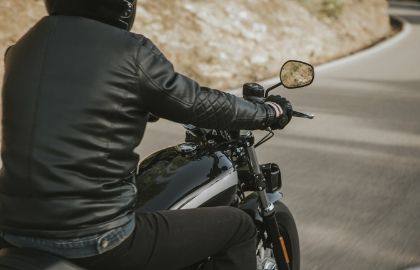 man riding motorcycle in leather jacket