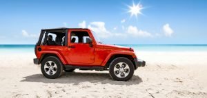 ed jeep with soft top in a beach