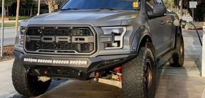 gray ford f150 with shocks in street